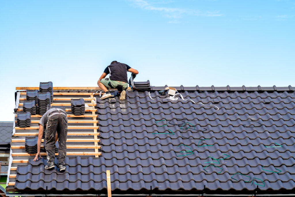 craftsman builds a new roof from ceramic tiles