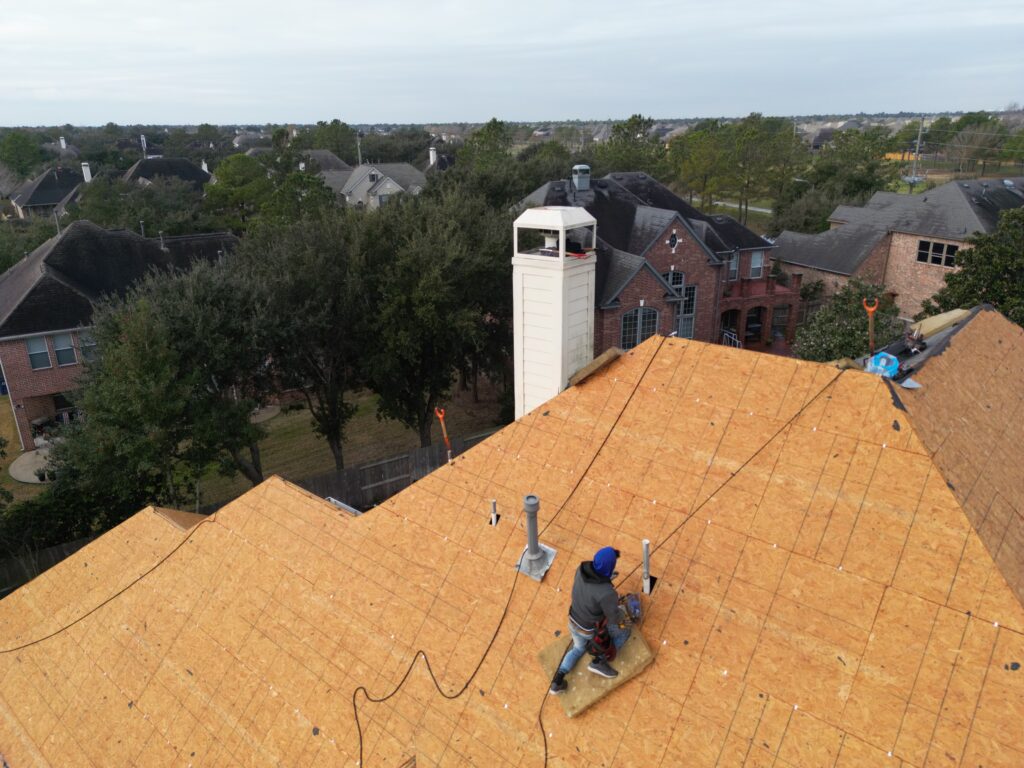 Roof replacement in progress with new wood roof sheathing