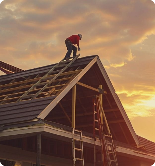 worker installing a roof truss on a residential home